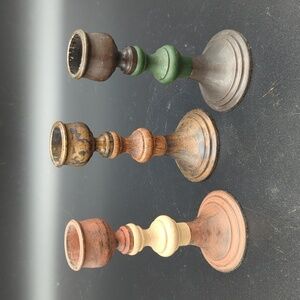 Set of three metal and wood small candle stick holders